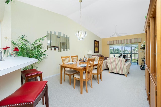 carpeted dining area featuring vaulted ceiling and ceiling fan with notable chandelier