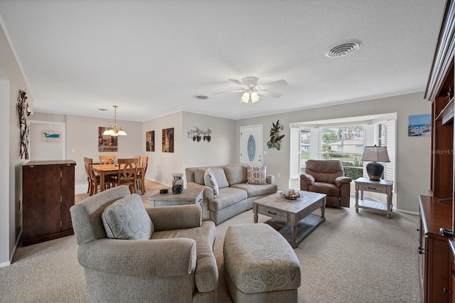 living room with light carpet, ceiling fan with notable chandelier, and a textured ceiling