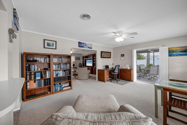 office featuring carpet floors, ornamental molding, and ceiling fan