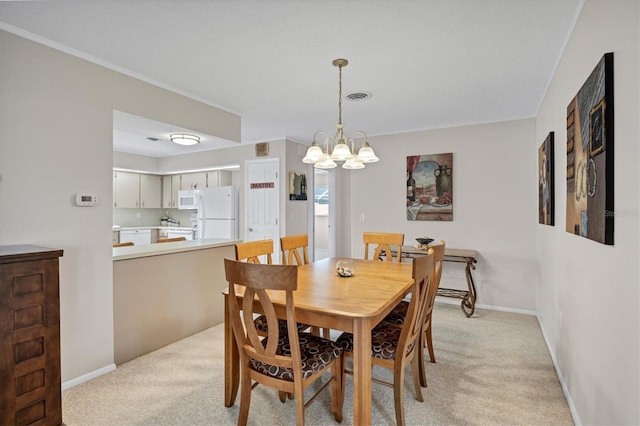 dining room with light carpet and an inviting chandelier