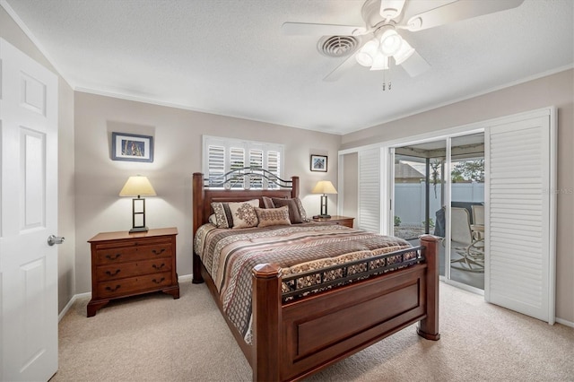 carpeted bedroom with access to exterior, a textured ceiling, and ceiling fan