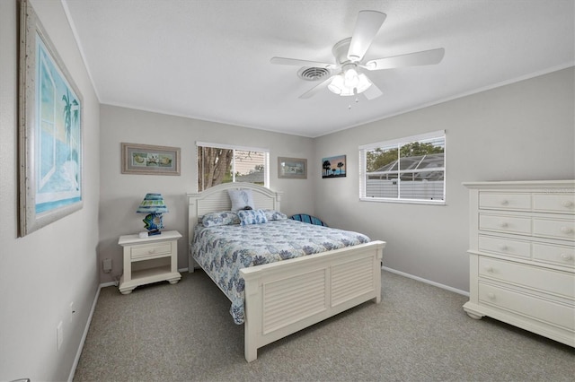 carpeted bedroom with ceiling fan and multiple windows