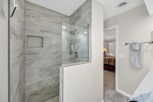 ensuite bathroom featuring baseboards, visible vents, walk in shower, and ensuite bathroom