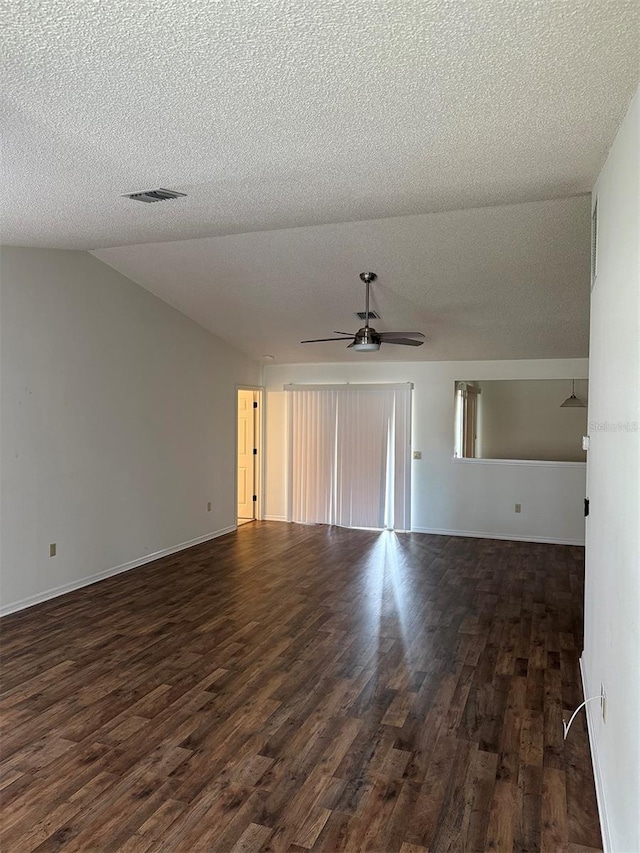 unfurnished living room featuring a textured ceiling, dark wood-type flooring, and lofted ceiling