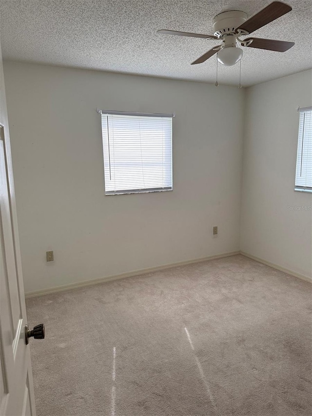 empty room featuring ceiling fan and a textured ceiling