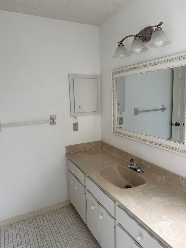 bathroom featuring vanity, tile patterned flooring, and a textured ceiling