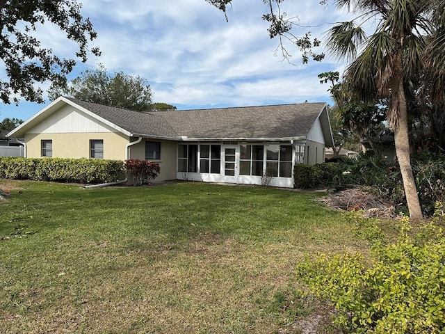 exterior space featuring a front lawn and a sunroom