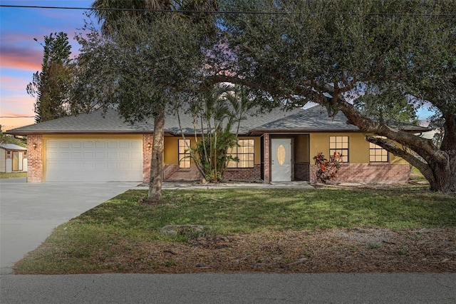 view of front of house with a garage and a lawn