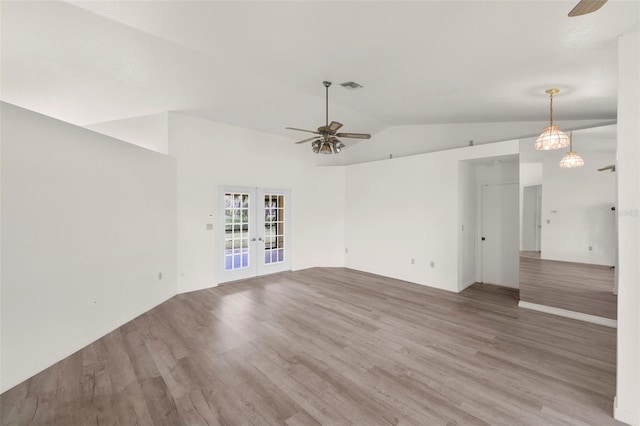 spare room with french doors, ceiling fan, vaulted ceiling, and hardwood / wood-style flooring