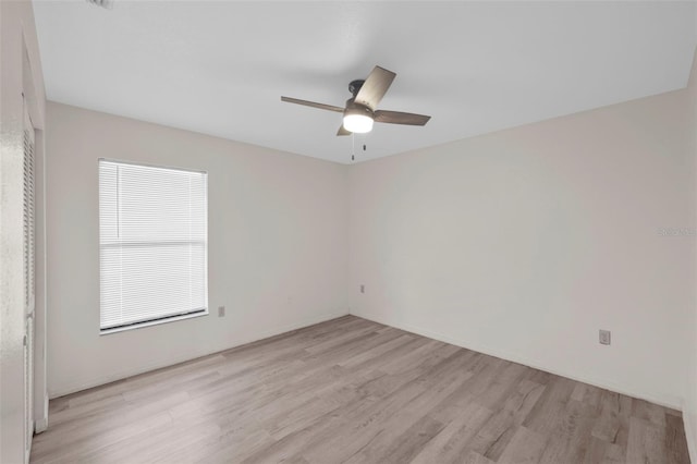 unfurnished room with ceiling fan and light wood-type flooring