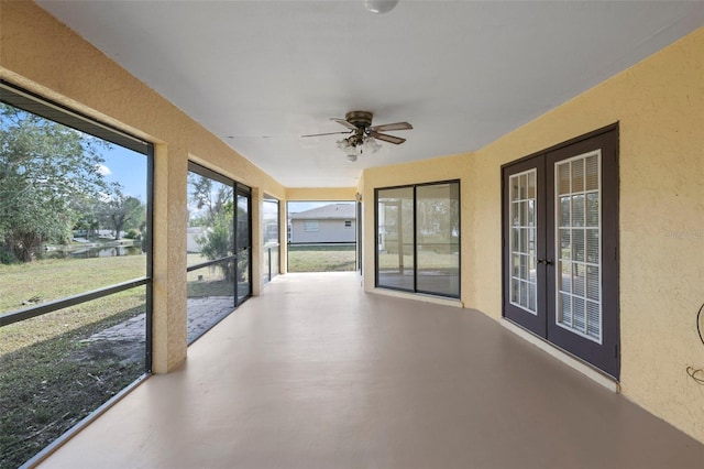 unfurnished sunroom featuring french doors and ceiling fan