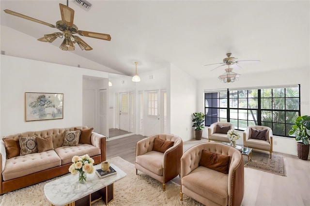 living room with lofted ceiling, ceiling fan, and hardwood / wood-style floors