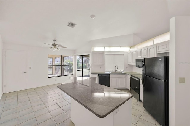 kitchen with white cabinets, black appliances, a center island, light tile patterned floors, and sink