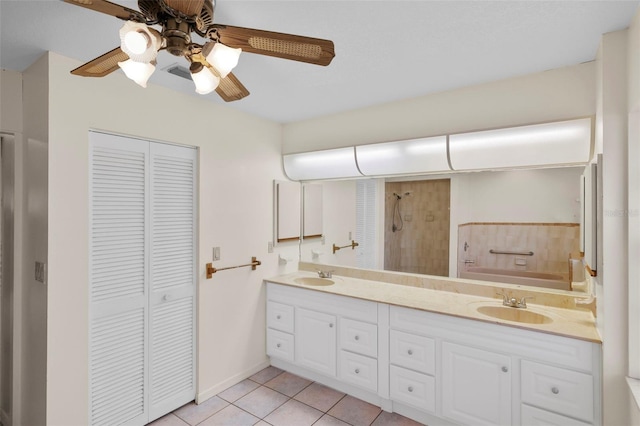 bathroom with a shower, ceiling fan, tile patterned flooring, and vanity