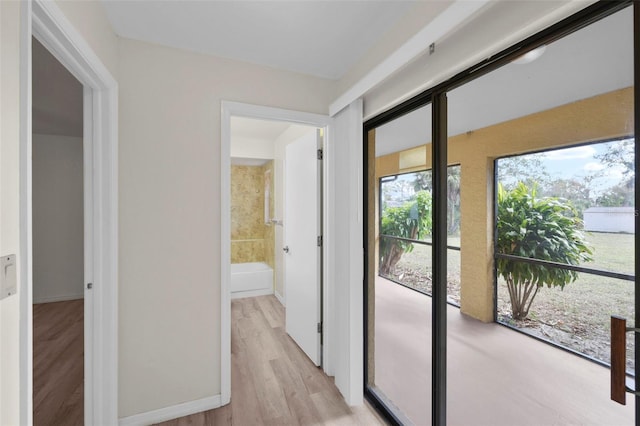 corridor with light hardwood / wood-style floors