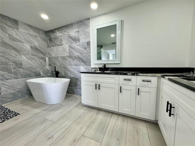 bathroom featuring vanity and a tub