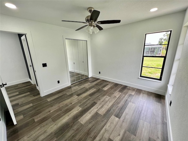 unfurnished bedroom with dark wood-type flooring and ceiling fan