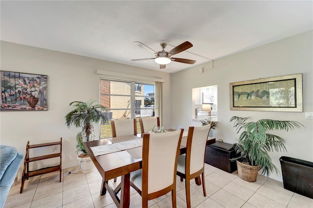 tiled dining room featuring ceiling fan