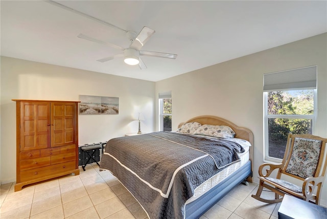 bedroom with ceiling fan and light tile patterned floors