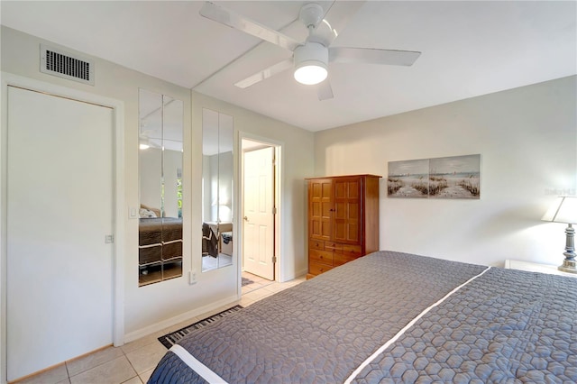 tiled bedroom featuring ceiling fan