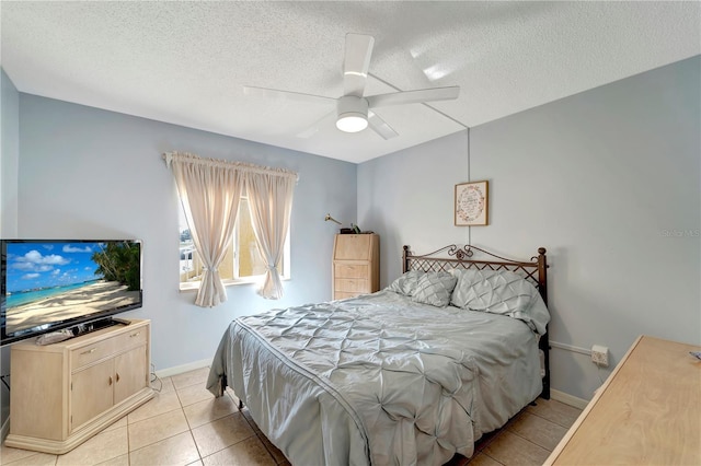 tiled bedroom featuring ceiling fan and a textured ceiling