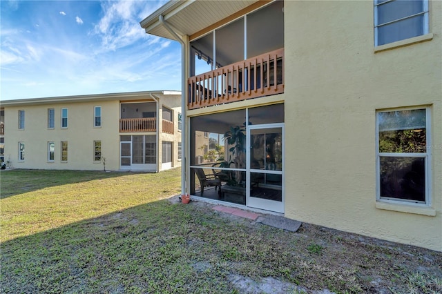 rear view of house featuring a yard