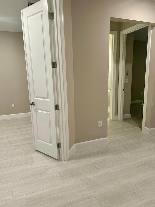 corridor featuring light tile patterned floors