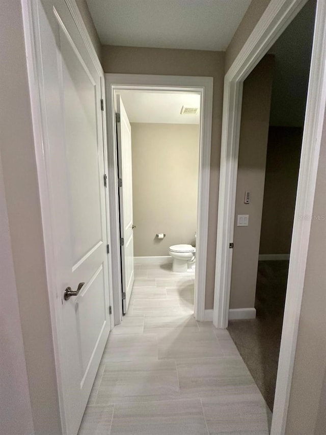 hallway featuring light tile patterned floors