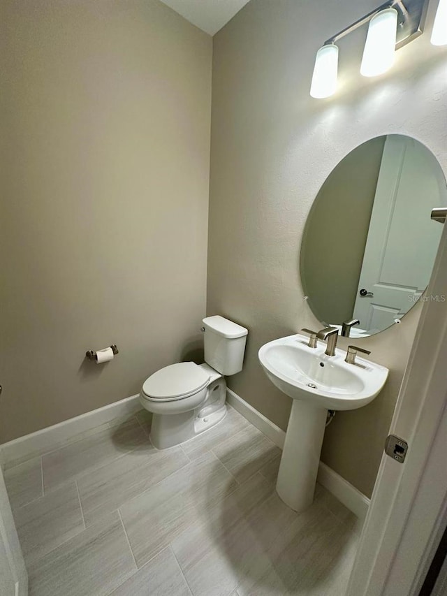 bathroom featuring toilet and tile patterned floors