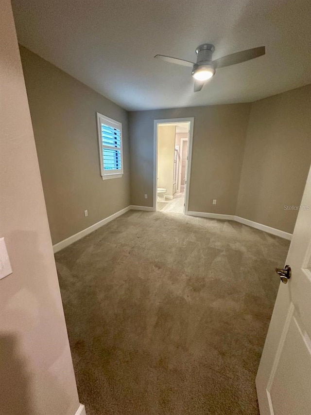 carpeted empty room with ceiling fan