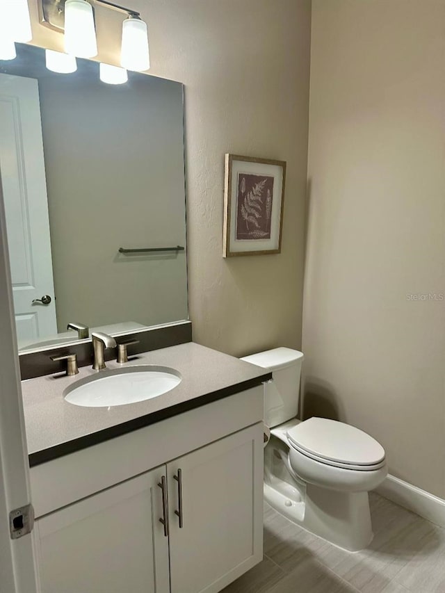 bathroom with toilet and vanity