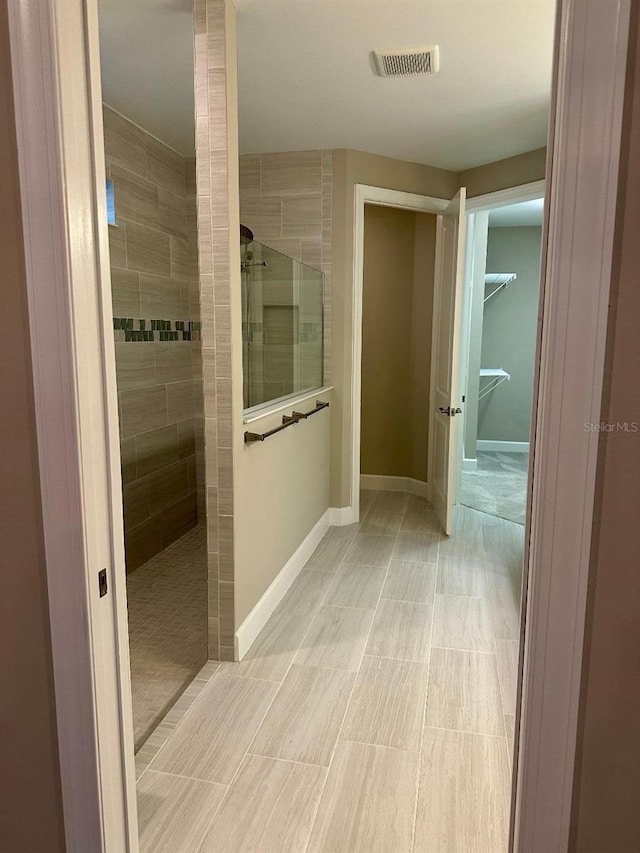 bathroom with a tile shower