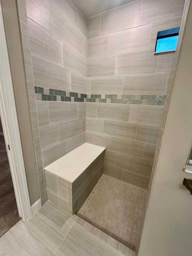 bathroom with a tile shower