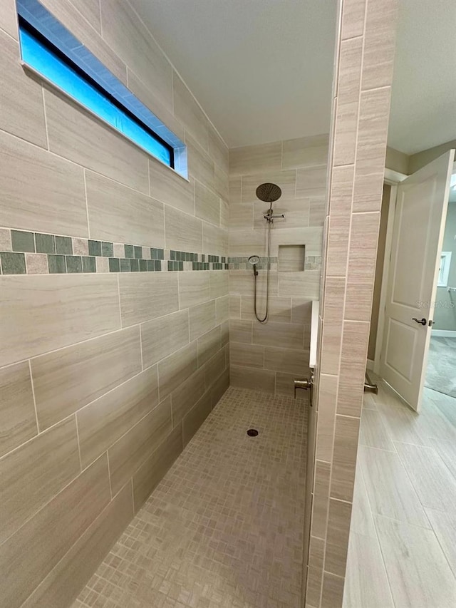 bathroom with a tile shower