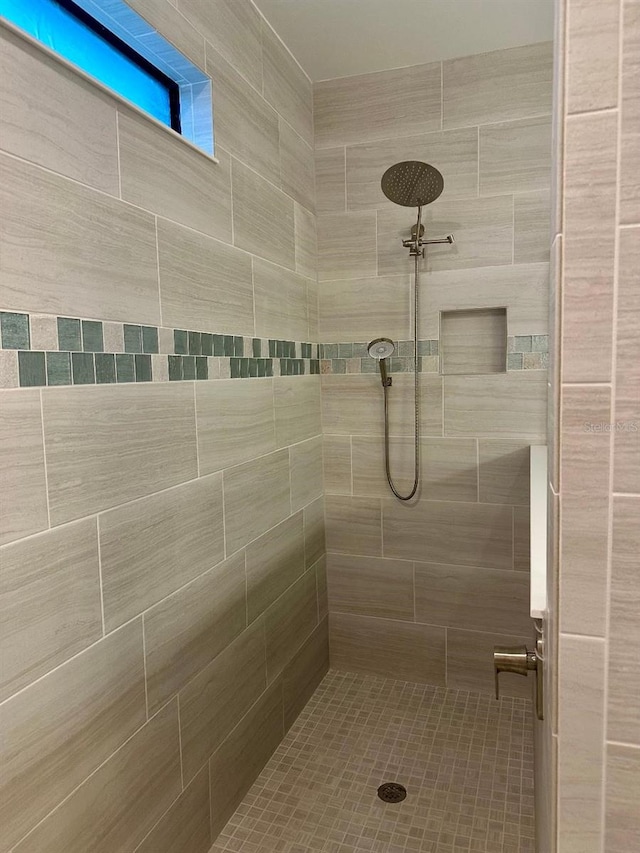 bathroom with tiled shower