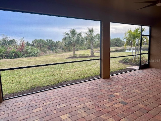 unfurnished sunroom with a water view