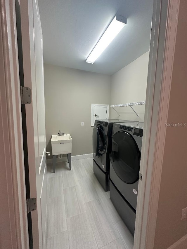 laundry area featuring washer and dryer and sink