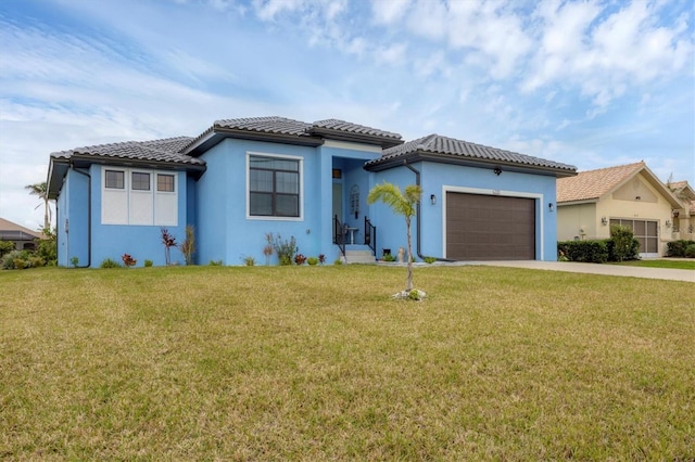 view of front of home with a front yard and a garage