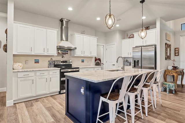 kitchen featuring white cabinetry, wall chimney exhaust hood, and stainless steel appliances