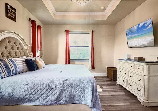 bedroom with a raised ceiling, dark wood-type flooring, and ornamental molding