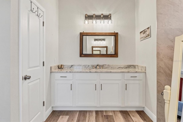 bathroom featuring vanity and hardwood / wood-style flooring