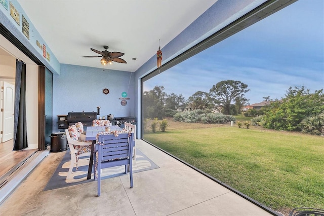 sunroom featuring ceiling fan