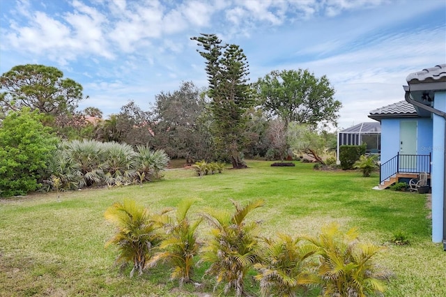 view of yard featuring glass enclosure