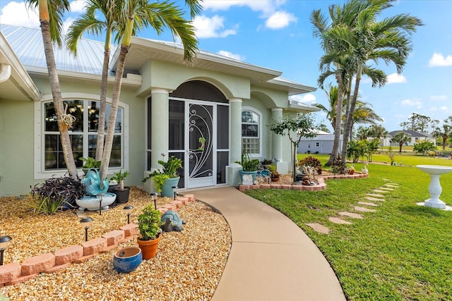 property entrance with a lawn