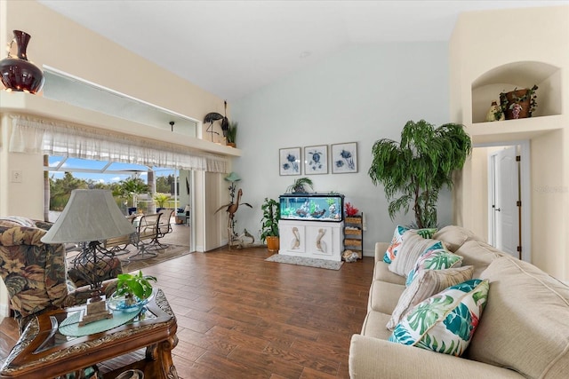 living room featuring dark wood-type flooring and vaulted ceiling