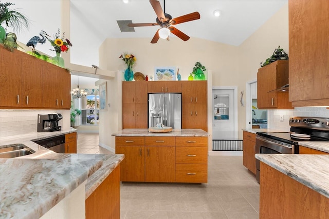 kitchen featuring light tile patterned floors, high vaulted ceiling, backsplash, stainless steel appliances, and ceiling fan with notable chandelier