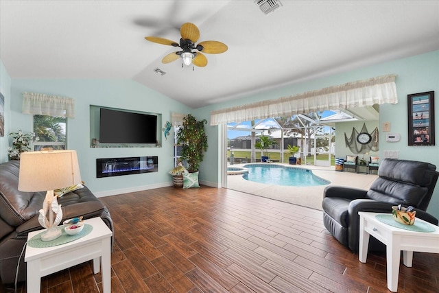 living room featuring ceiling fan and vaulted ceiling