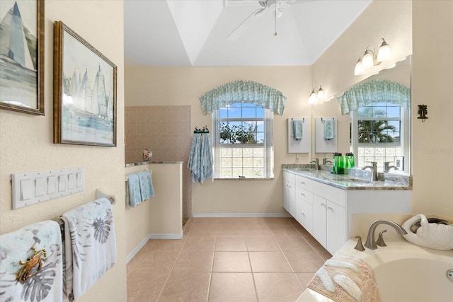 bathroom with vanity, a washtub, ceiling fan, and tile patterned flooring