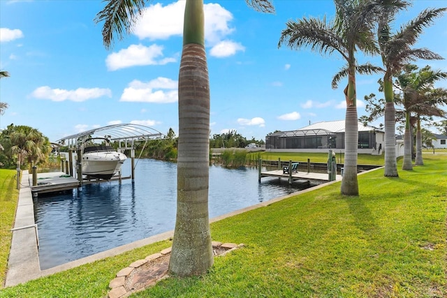 dock area with a lawn and a water view