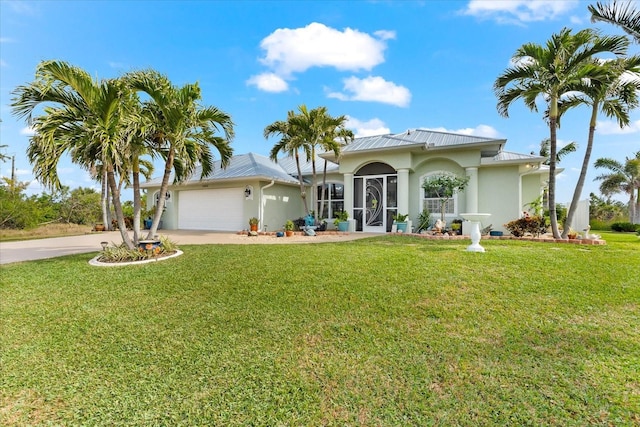 mediterranean / spanish-style home with a garage and a front lawn